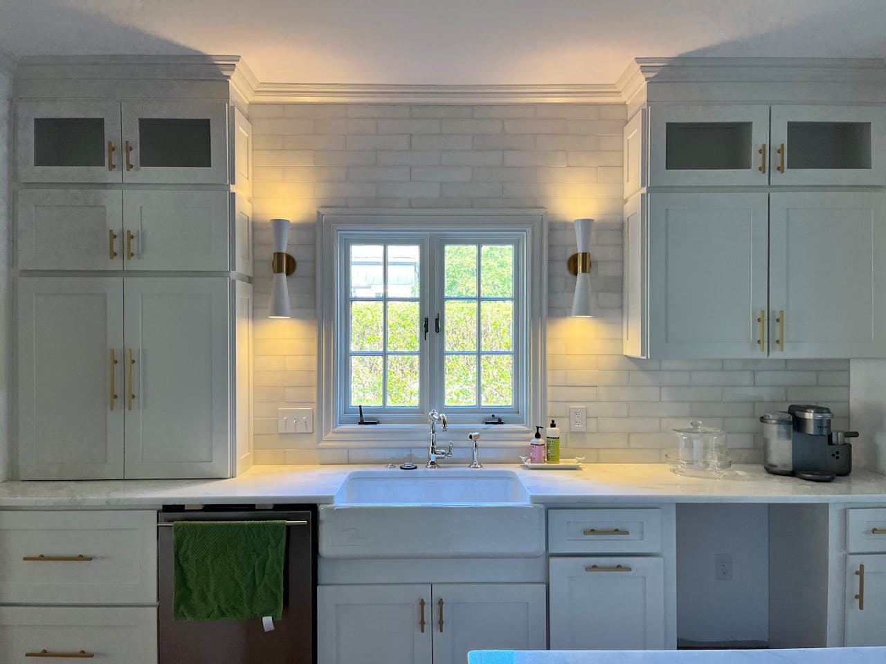 Bright kitchen with white cabinets, natural light, and modern fixtures.