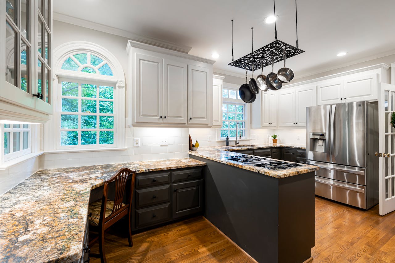 Bright modern kitchen with granite countertops, elegant cabinetry, and stainless steel appliances.